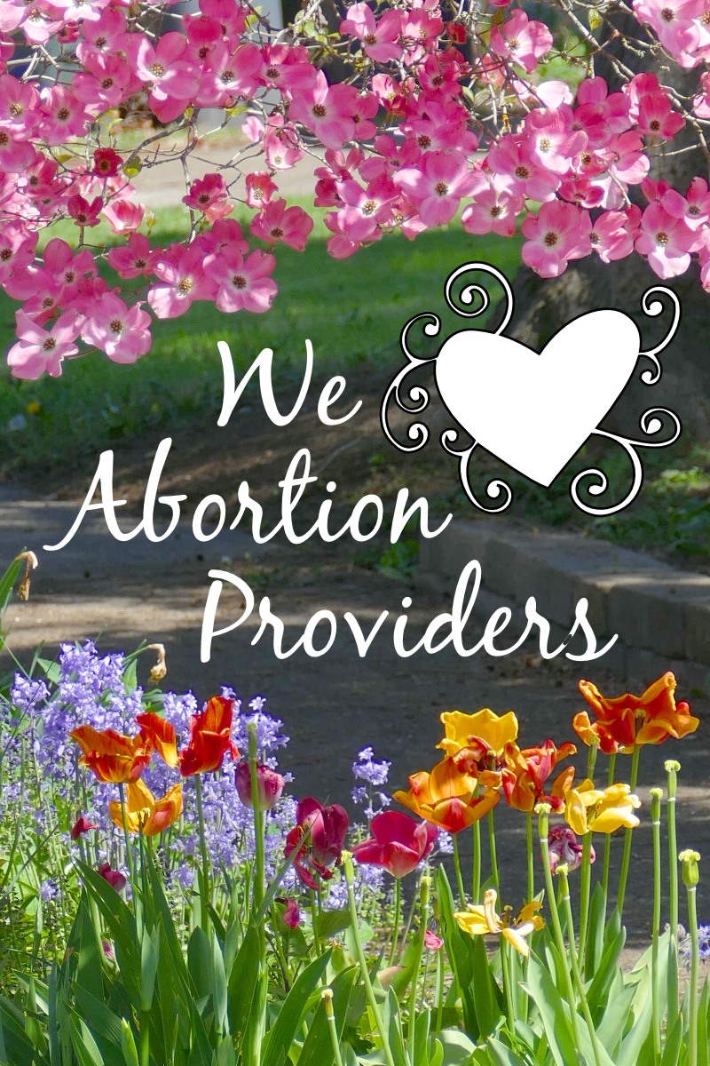 Tulips and pink Dogwood flowers and We Love Abortion Providers