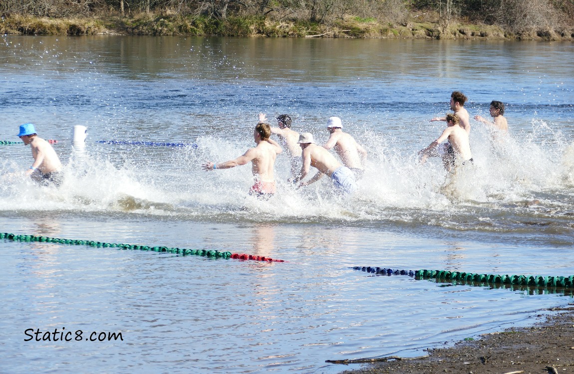 Men running into the water