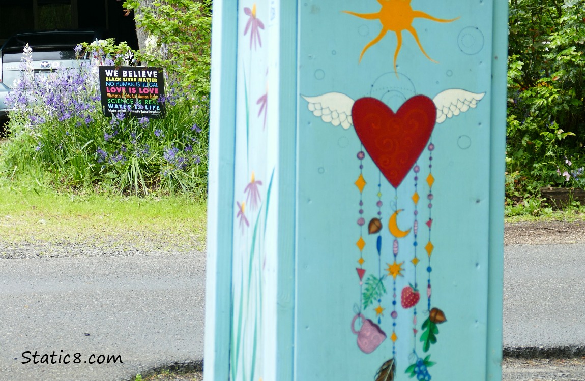 We Believe sign behind a free pantry box with cool art