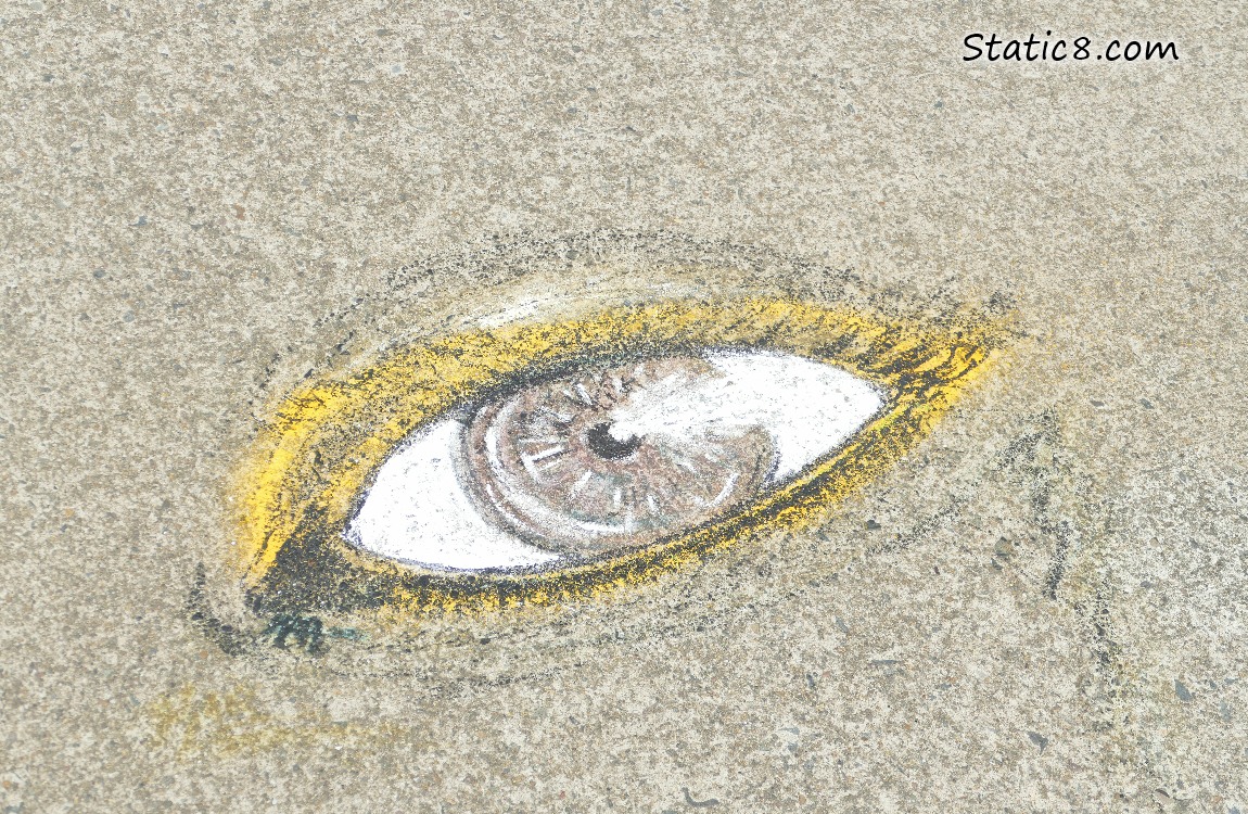 Chalk drawing of an eye on the path