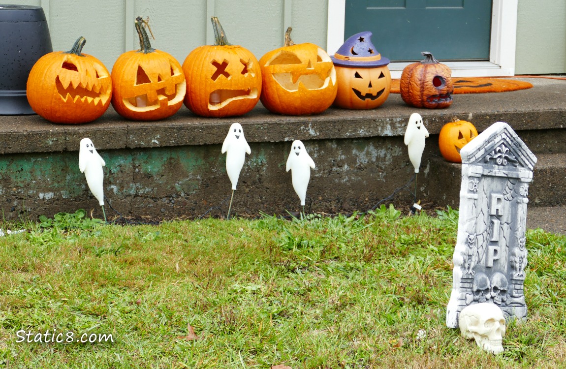 Jack-o-Lanterns on a porch with other decorations