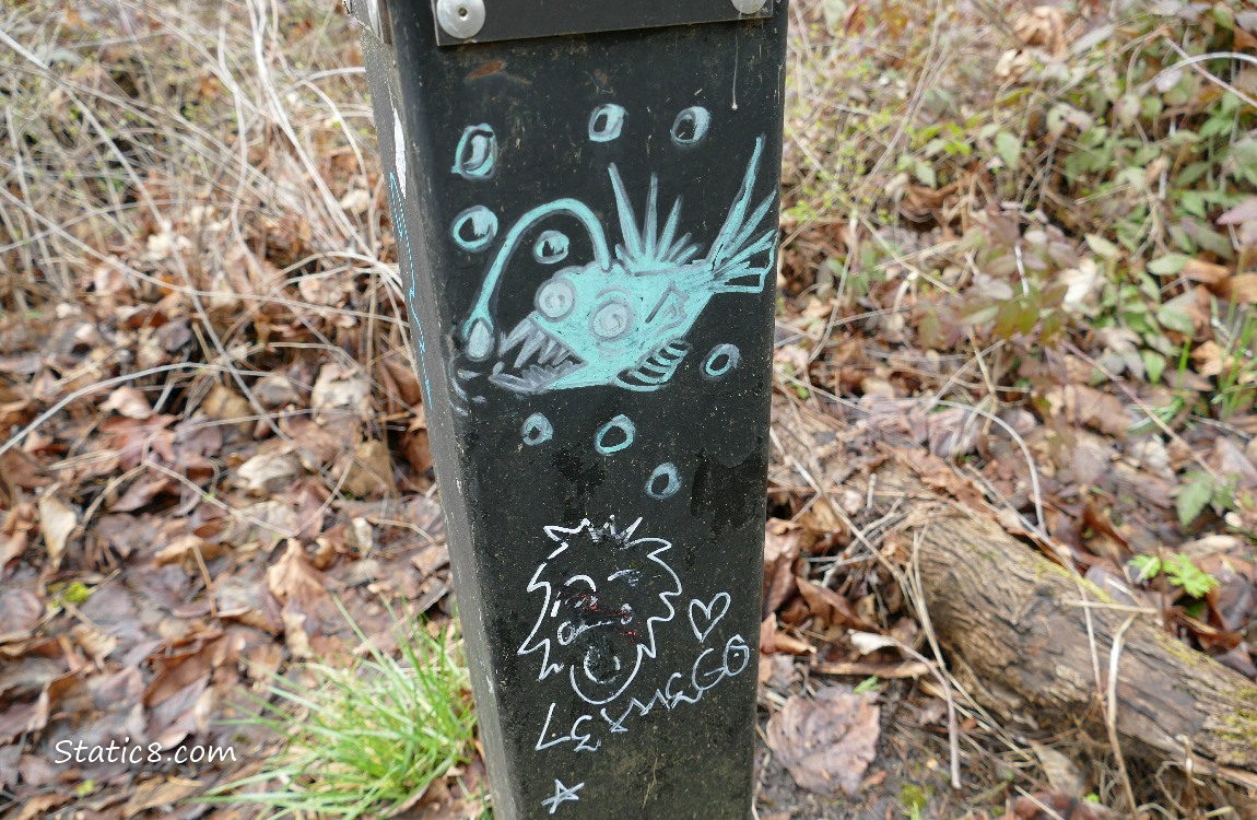 Graffiti of an Anglerfish on a black post