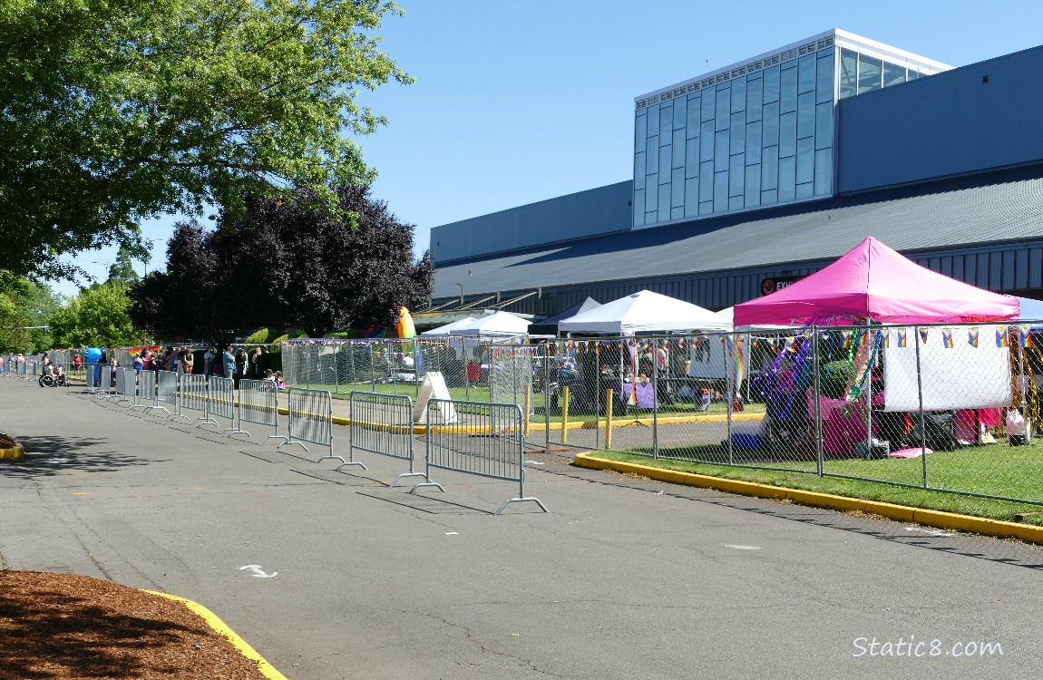 Vendor tents behind a chain link fence