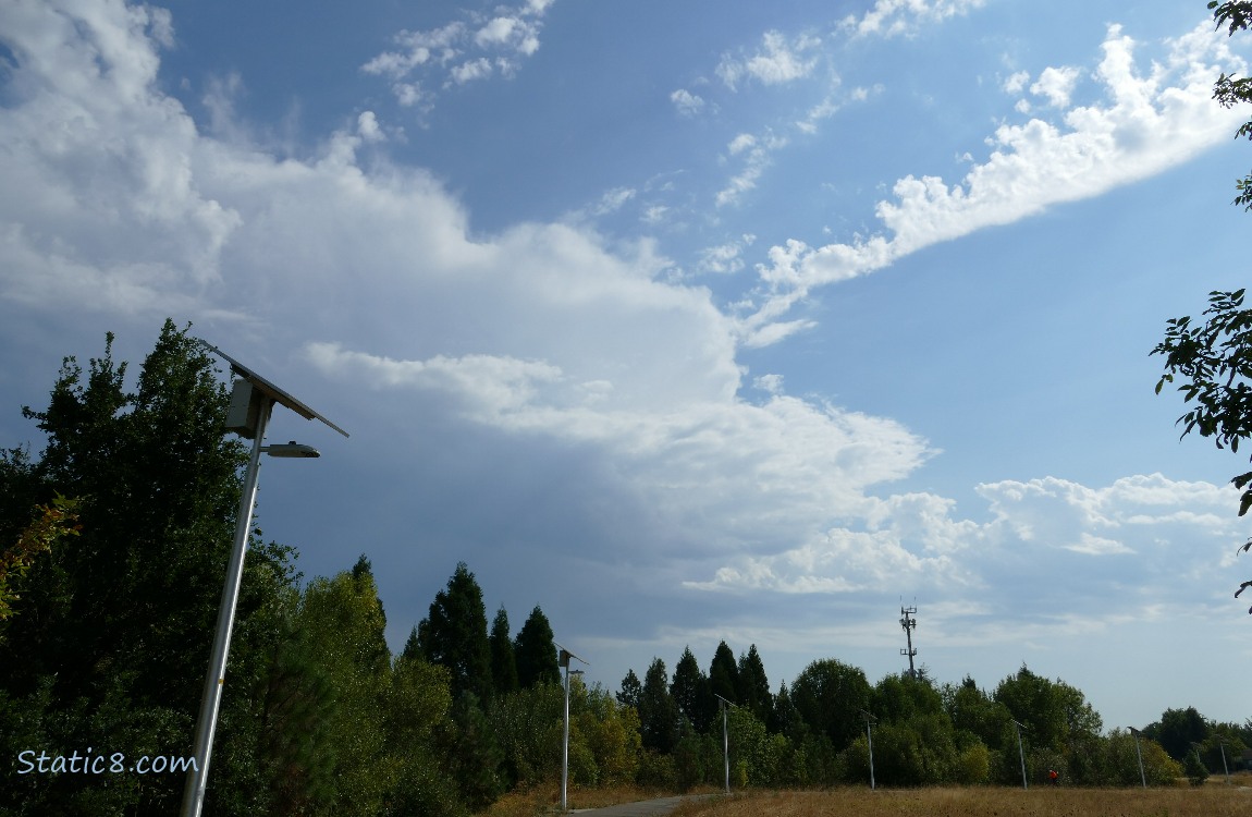 Clouds over the bike path with solar lamps