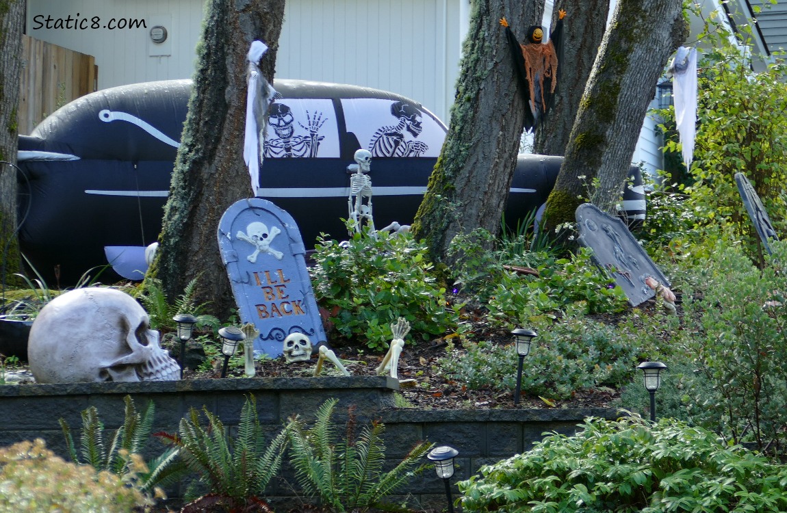 Halloween display with human skulls, skeletons and grave markers
