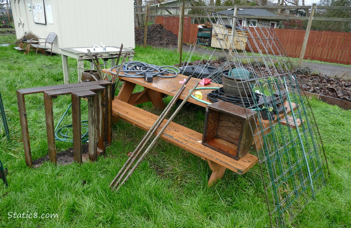 Picnic table with garden items on and around it