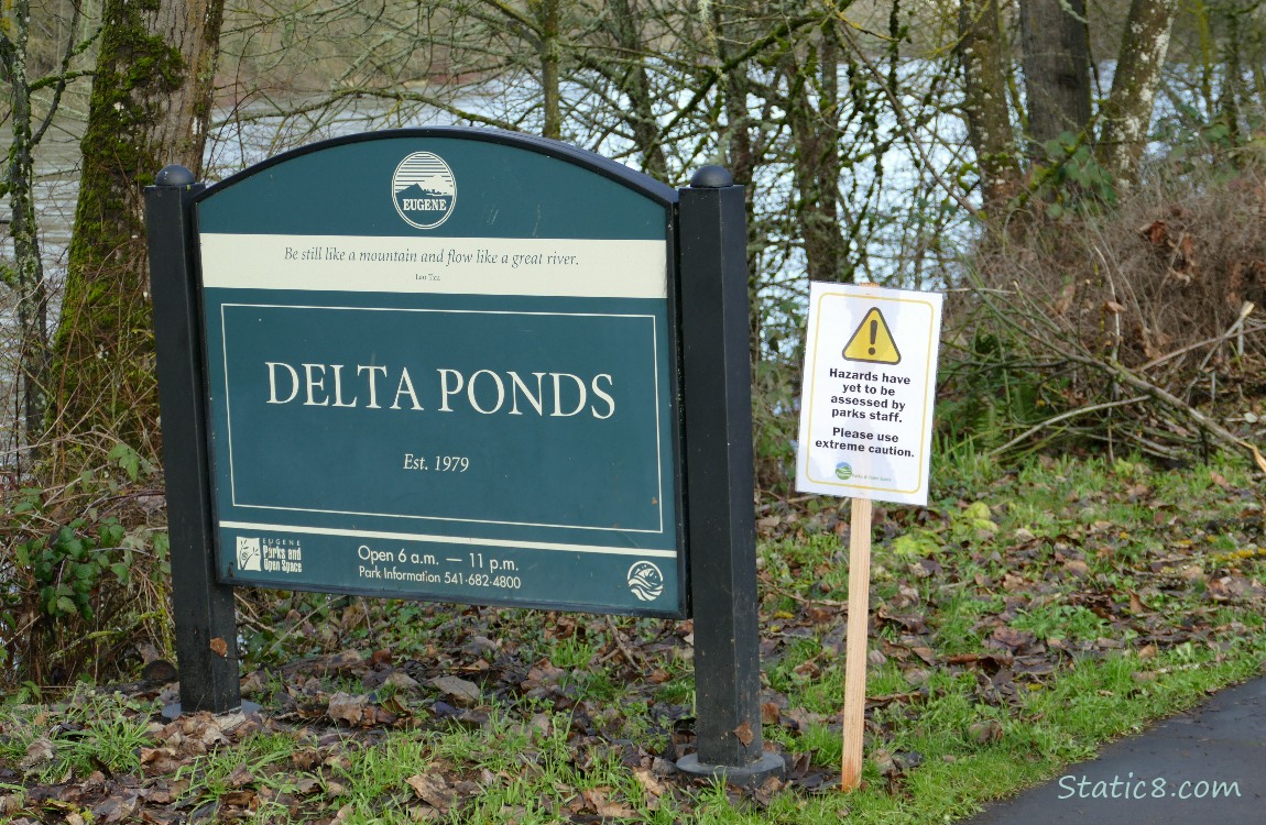 Small printed *Hazards* sign, next to official *Delta Ponds* sign