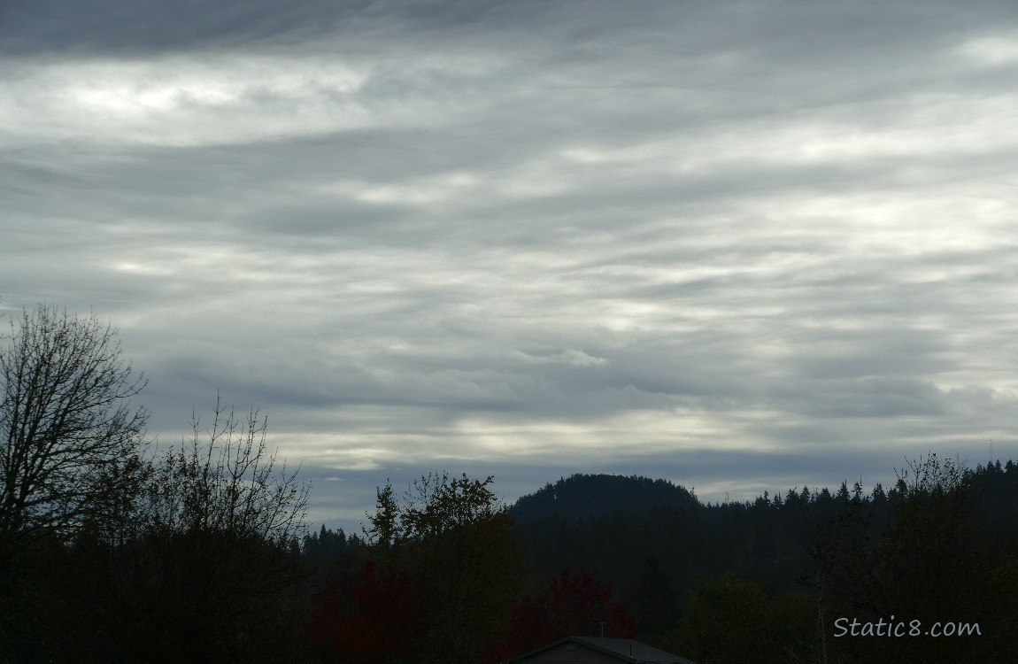 Layers of clouds over the silhouette of the hill