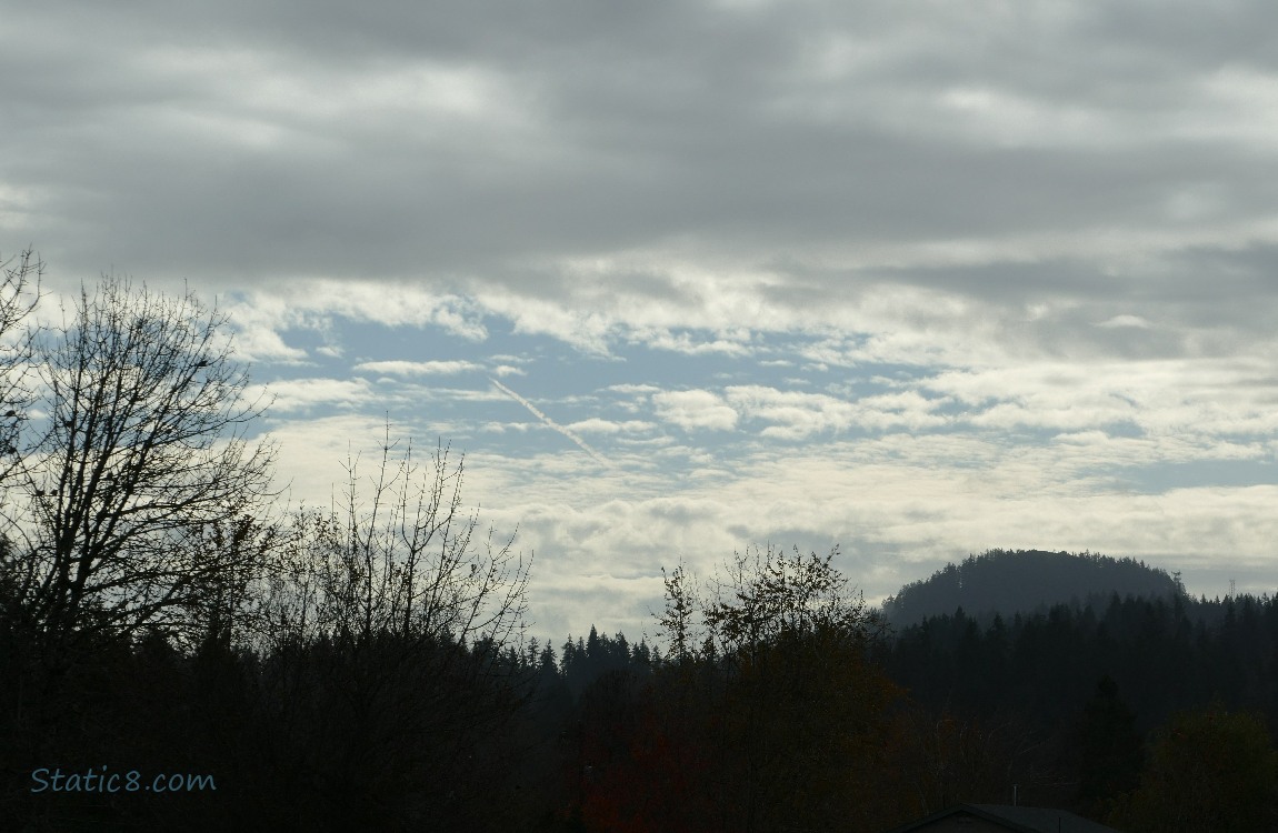 Clouds and a bit of blue sky over the hill