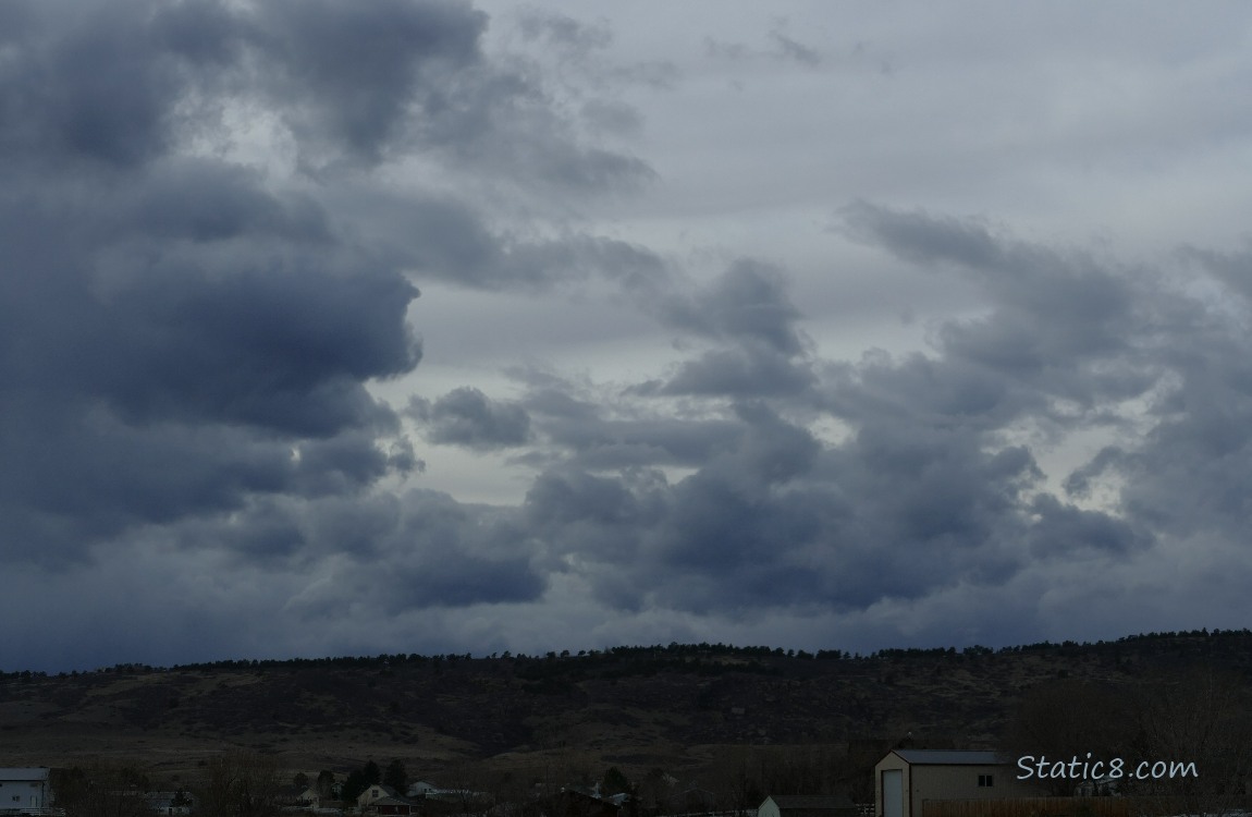 Puffy grey clouds over the foothills