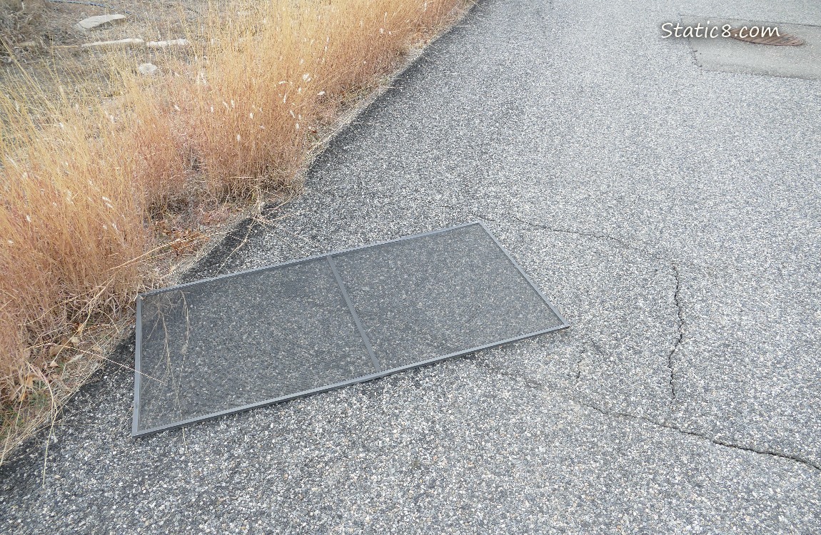 Screen window lying on the street