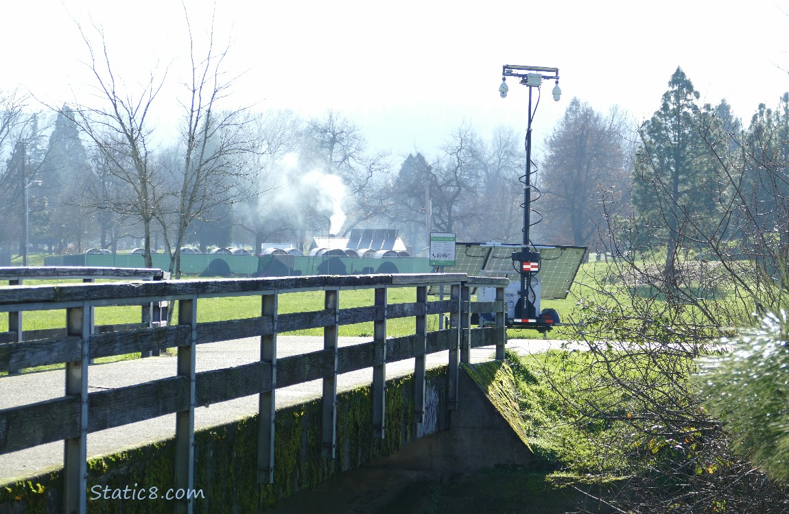 Police surveillance trailer on the other side of a walking bridge