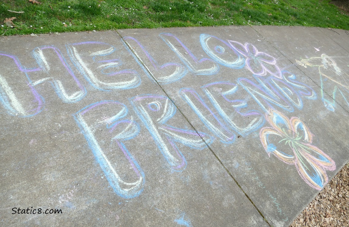 Hello Friends, written in chalk on a sidewalk