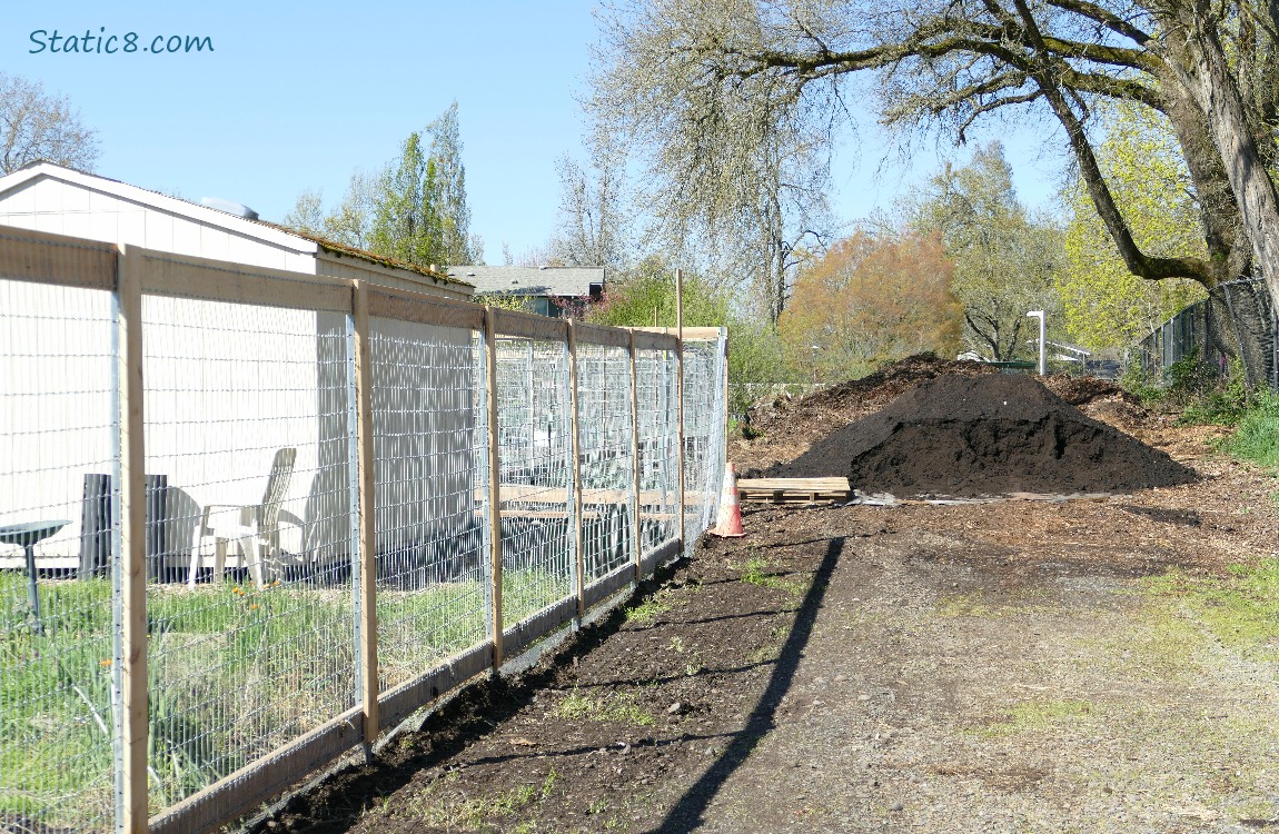 Pile of dirt next to the Community Garden fence