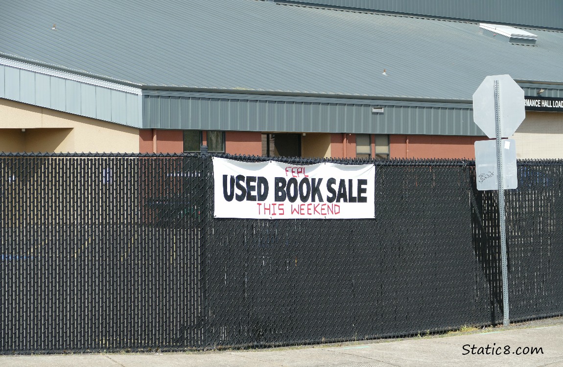 Used Book Sale, sign on a chain link fence