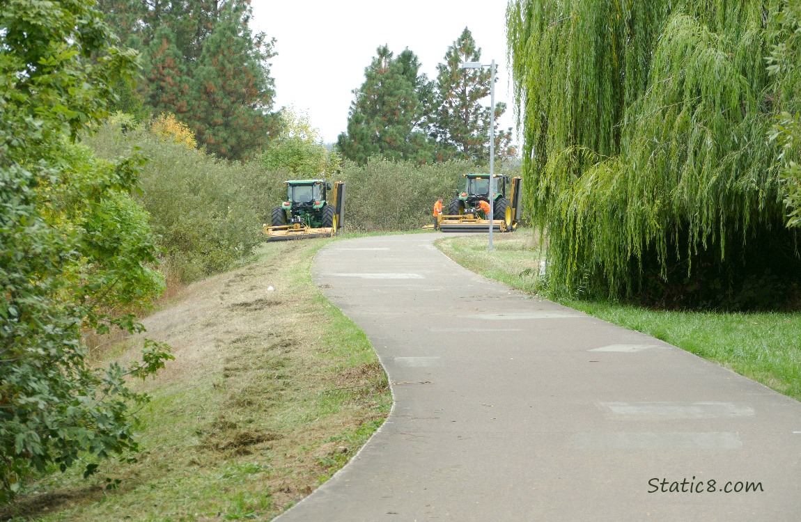 Tractor mowers stopped next to the bike path